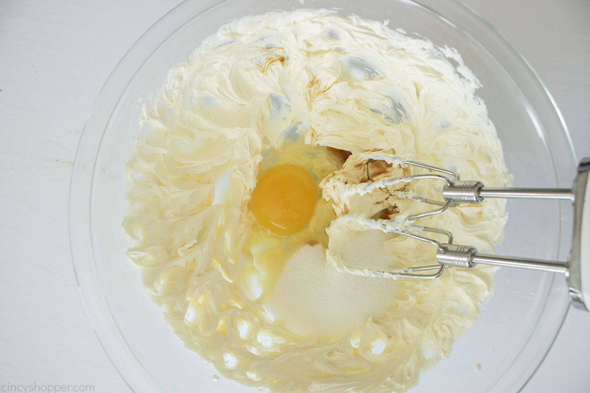 Egg, sugar and vanilla added to cream cheese.