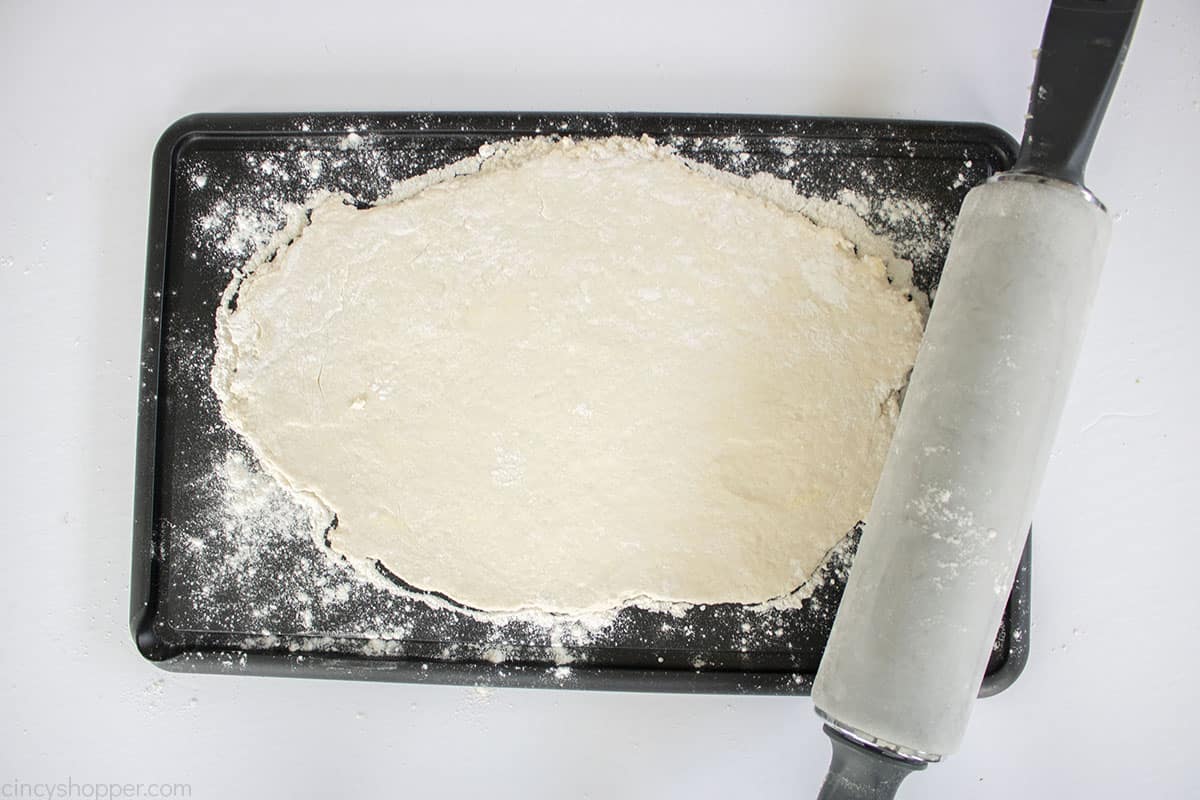 Dumpling dough rolled out with rolling pin.