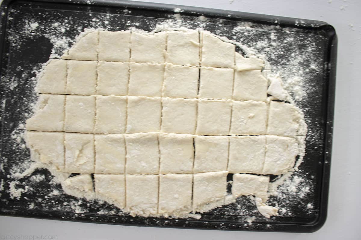 Cut homemade dumplings on a cutting board.