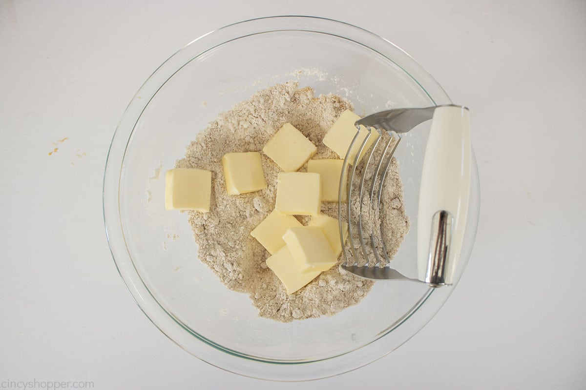 Butter added to streusel topping mixture and a pastry cutter.