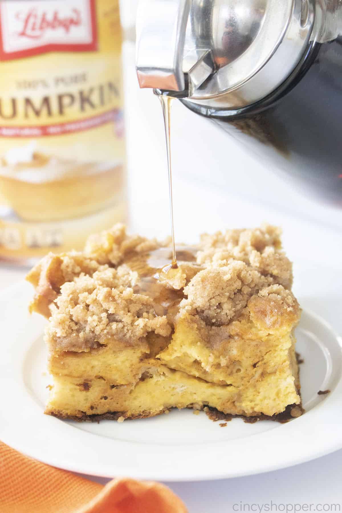 Piece of Pumpkin French Toast Bake with syrup pouring on top.