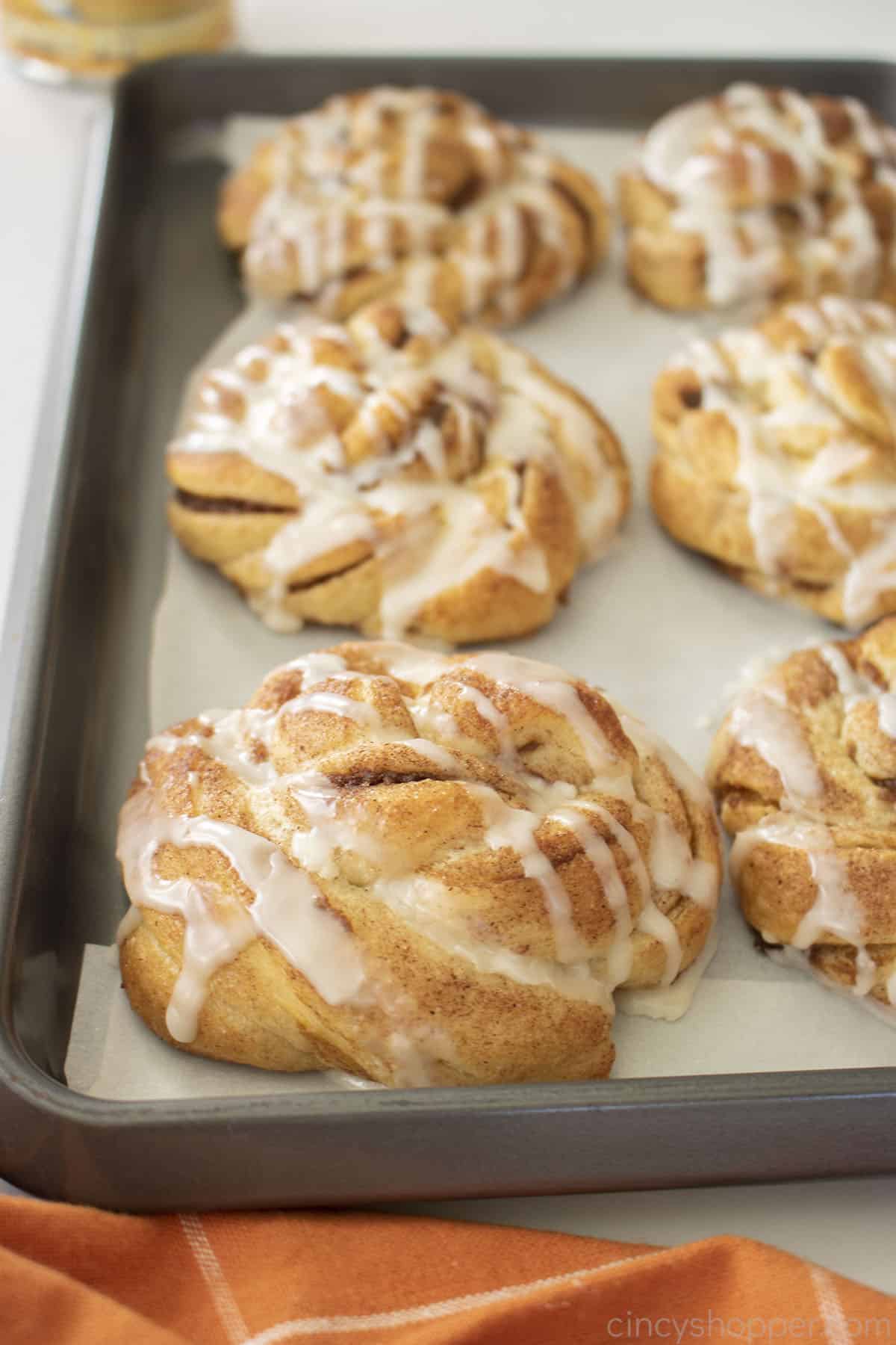 Easy pumpkin cinnamon rolls on a baking sheet.