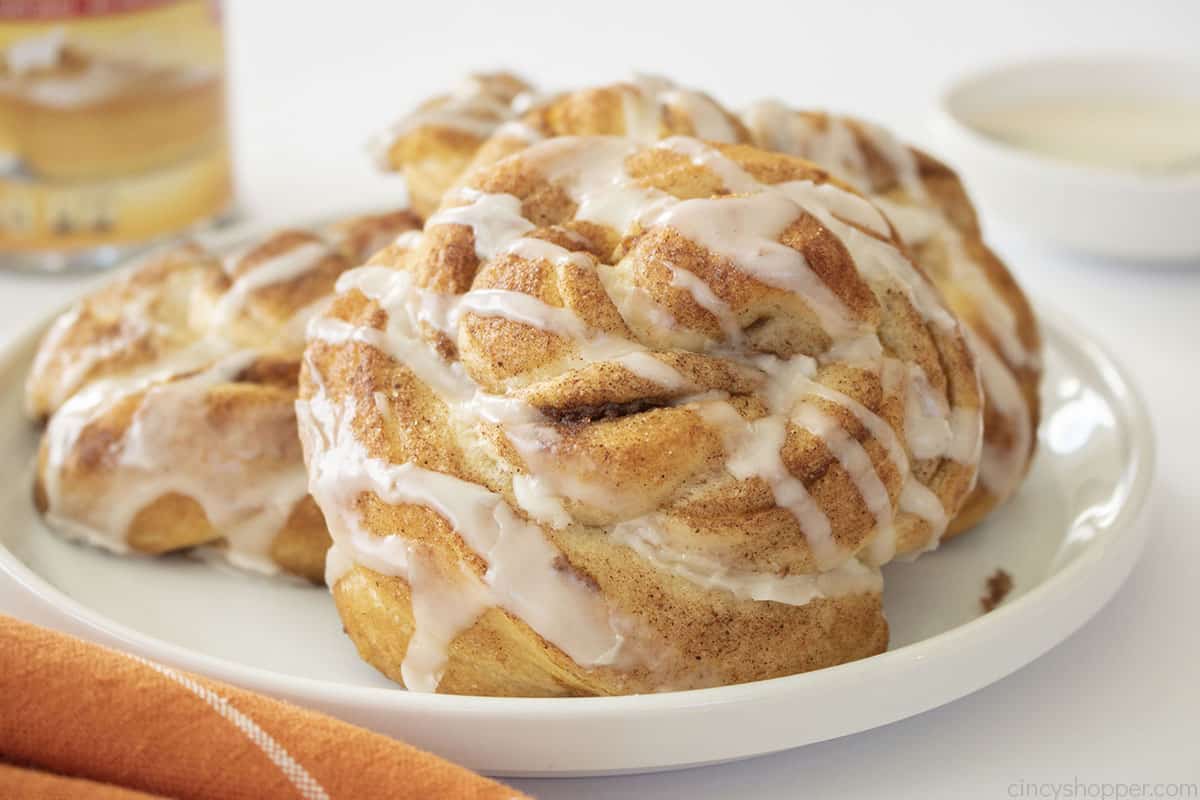 White plate with pumpkin cinnamon rolls.