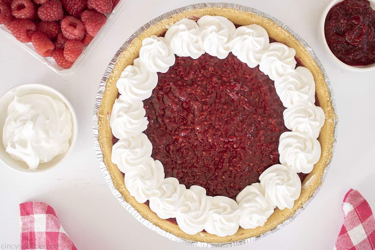 Dollops of whipped cream added to No Bake Raspberry Pie.