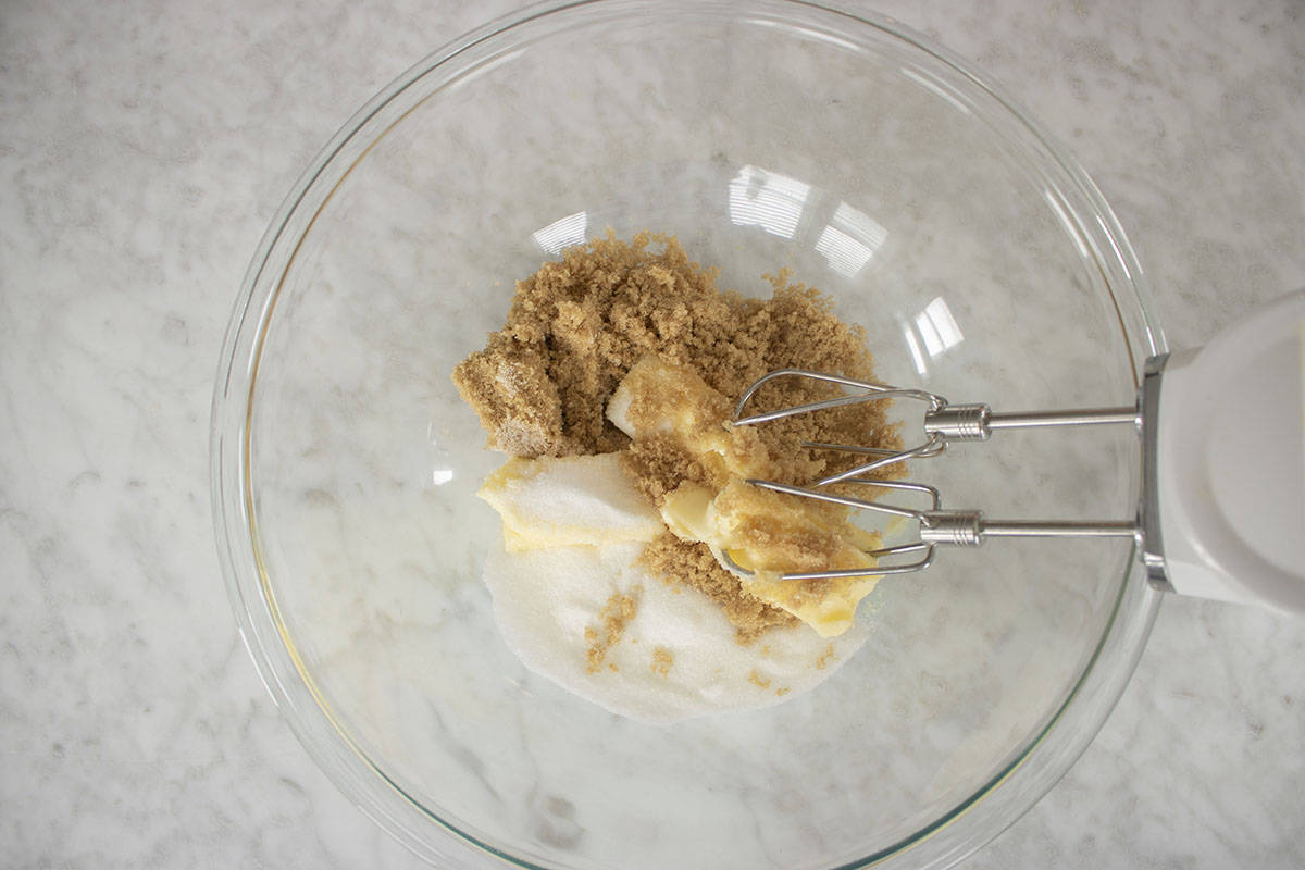 Cookie wet ingredients in a mixing bowl with hand mixer.