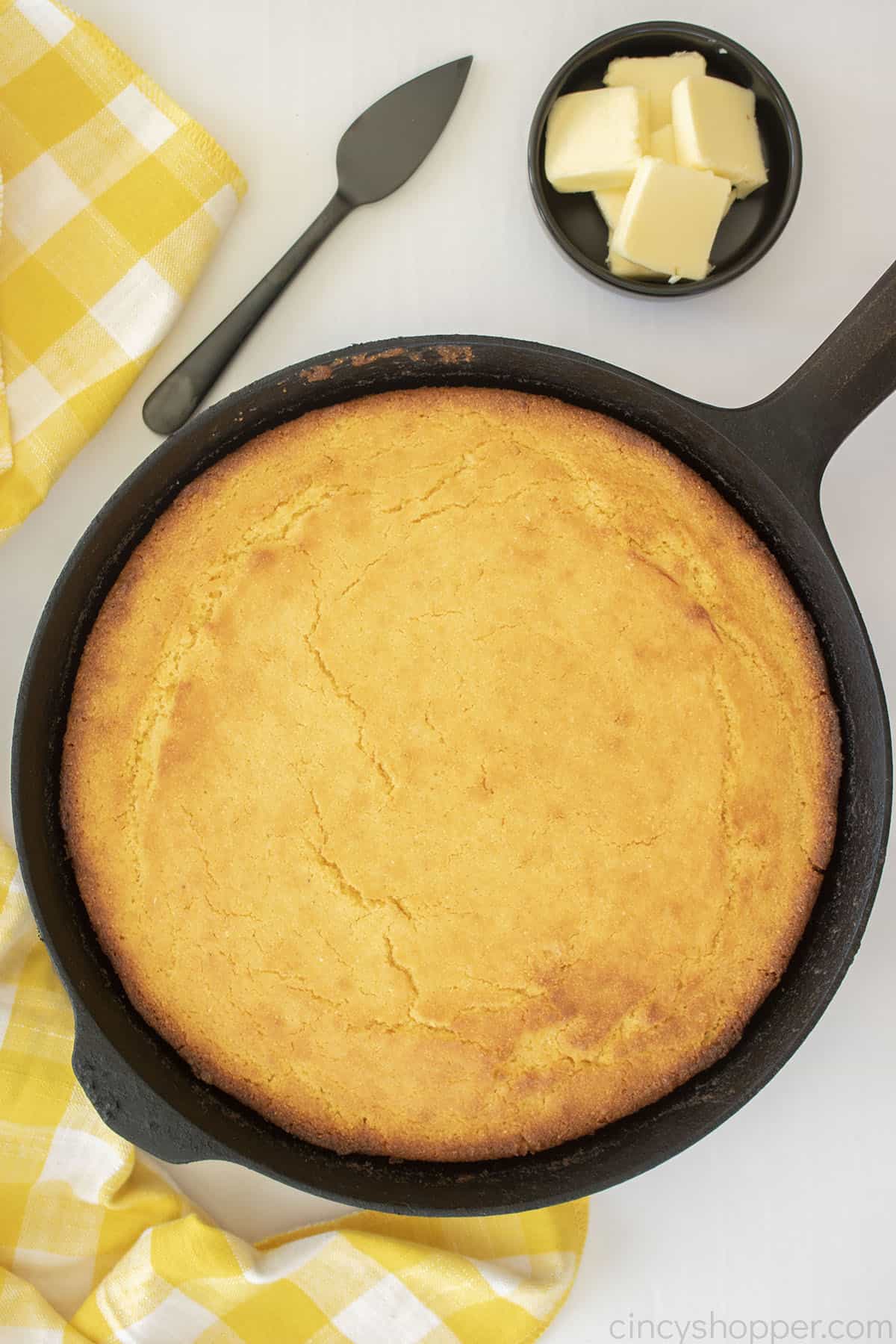 Old Fashioned Cornbread in a black cast iron skillet uncut.
