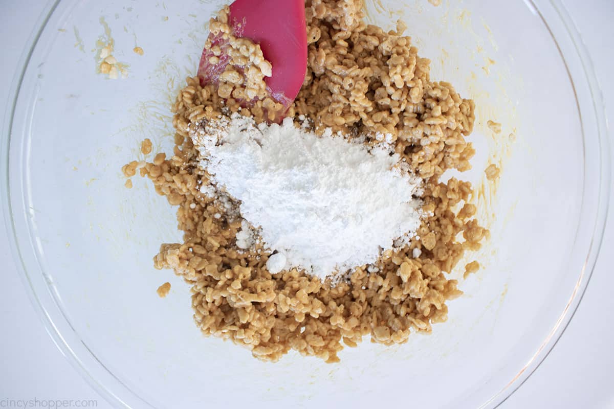 Powdered sugar added to peant butter rice crispy mixture.