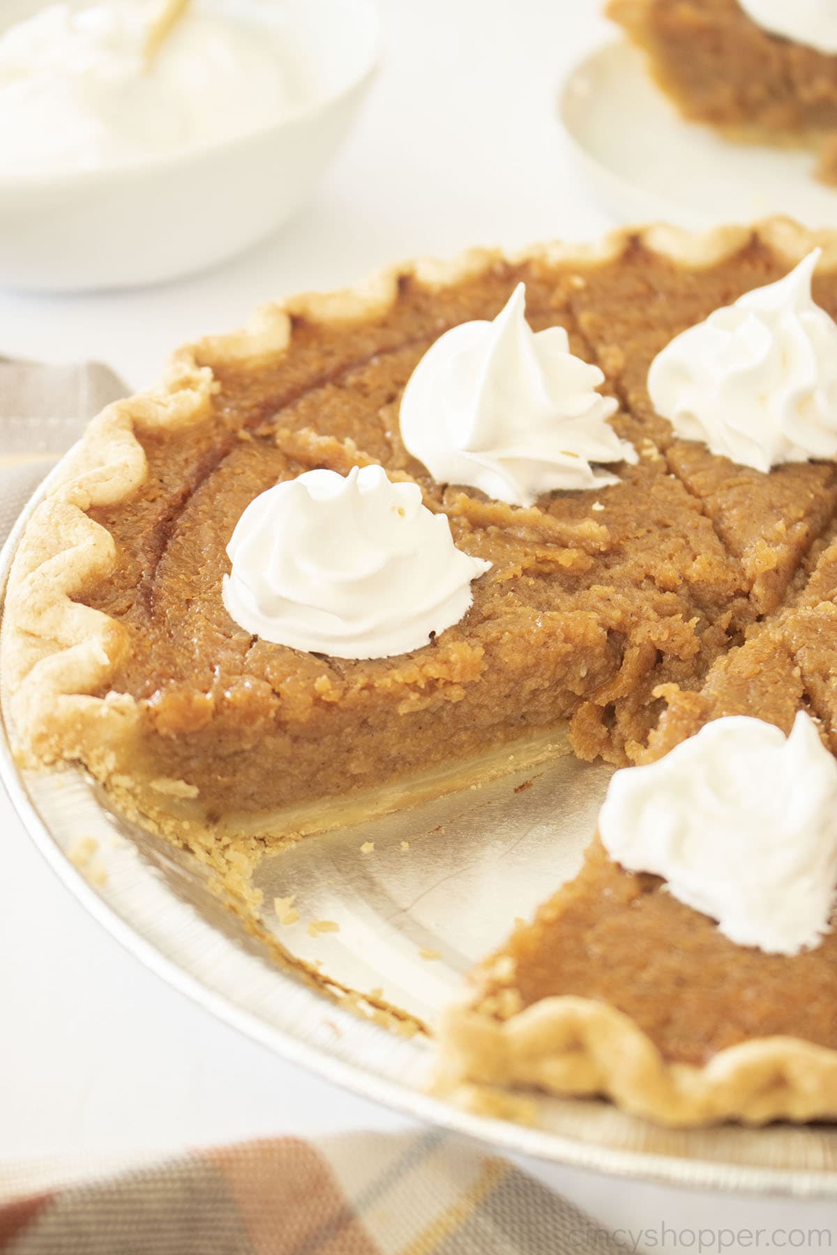 Sweet Potato pie with whipped cream in a pie pan.