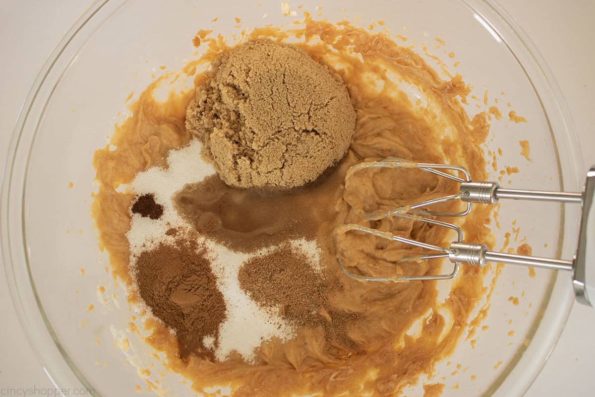 Sugars, spices and evaporated milk added to sweet potato custard mixture.