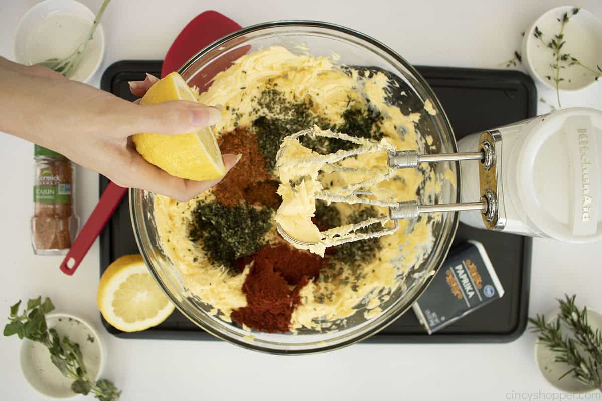 Cajun spices added to whipped butter in a mixing bowl.
