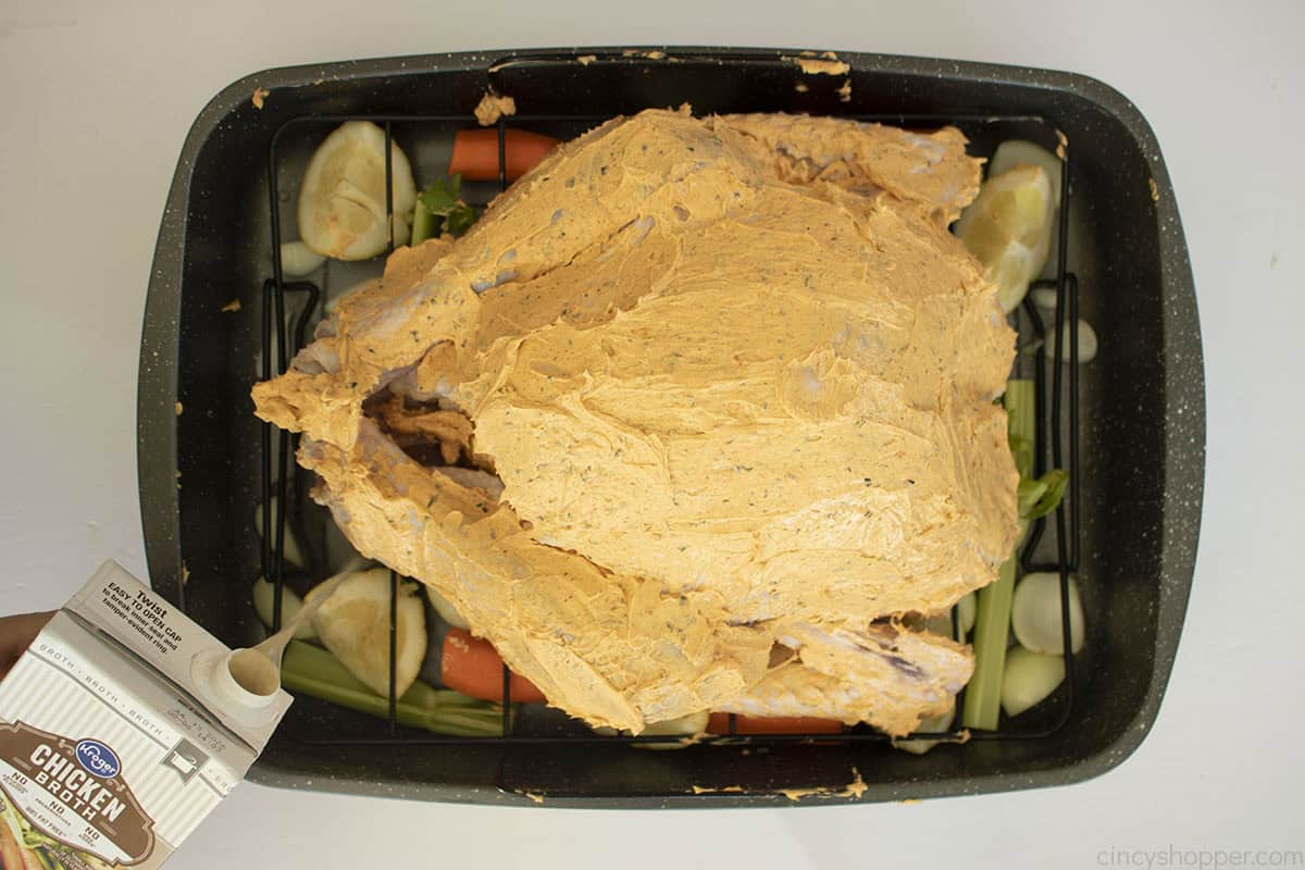 Broth added to roasting pan.