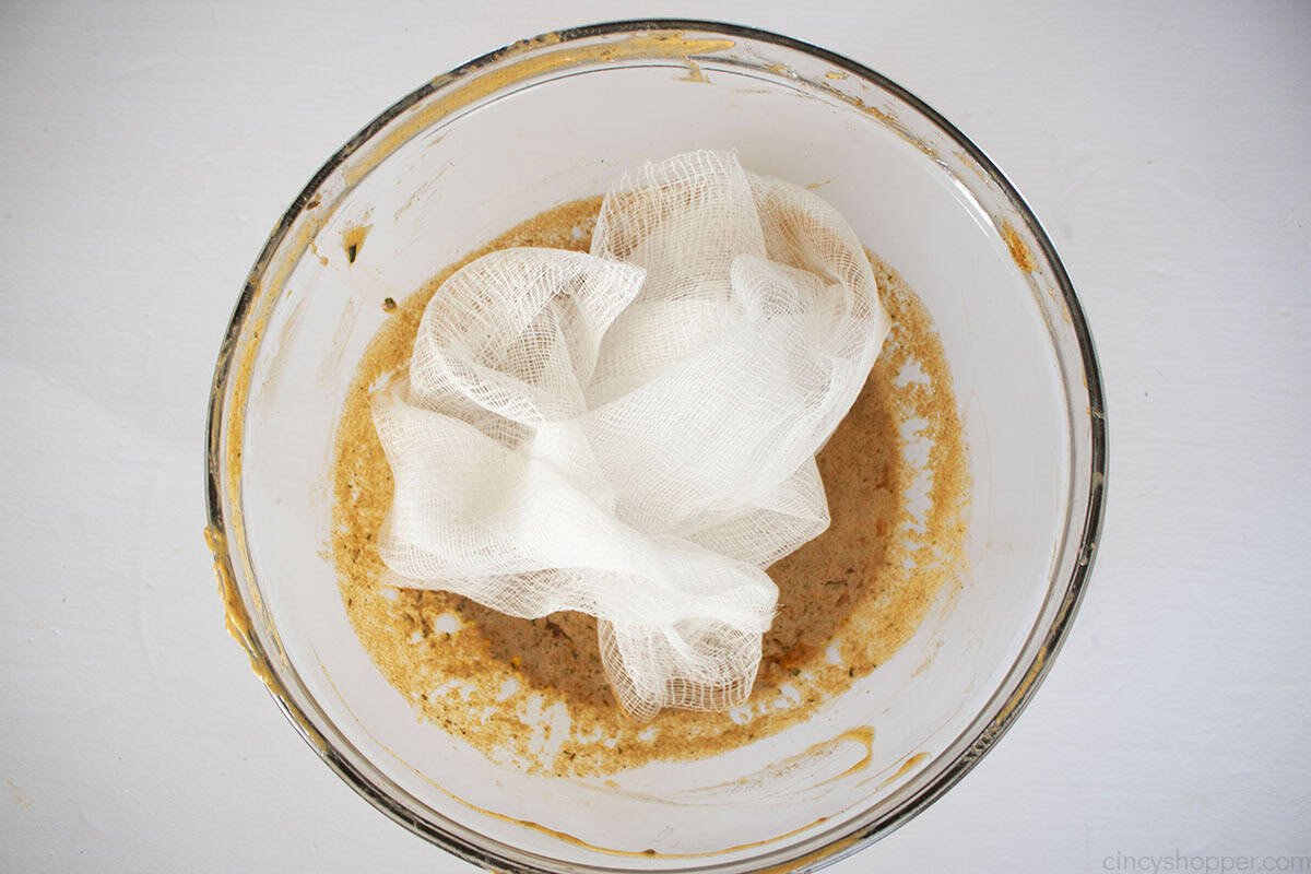 Cheesecloth added to melted cajun butter bowl.