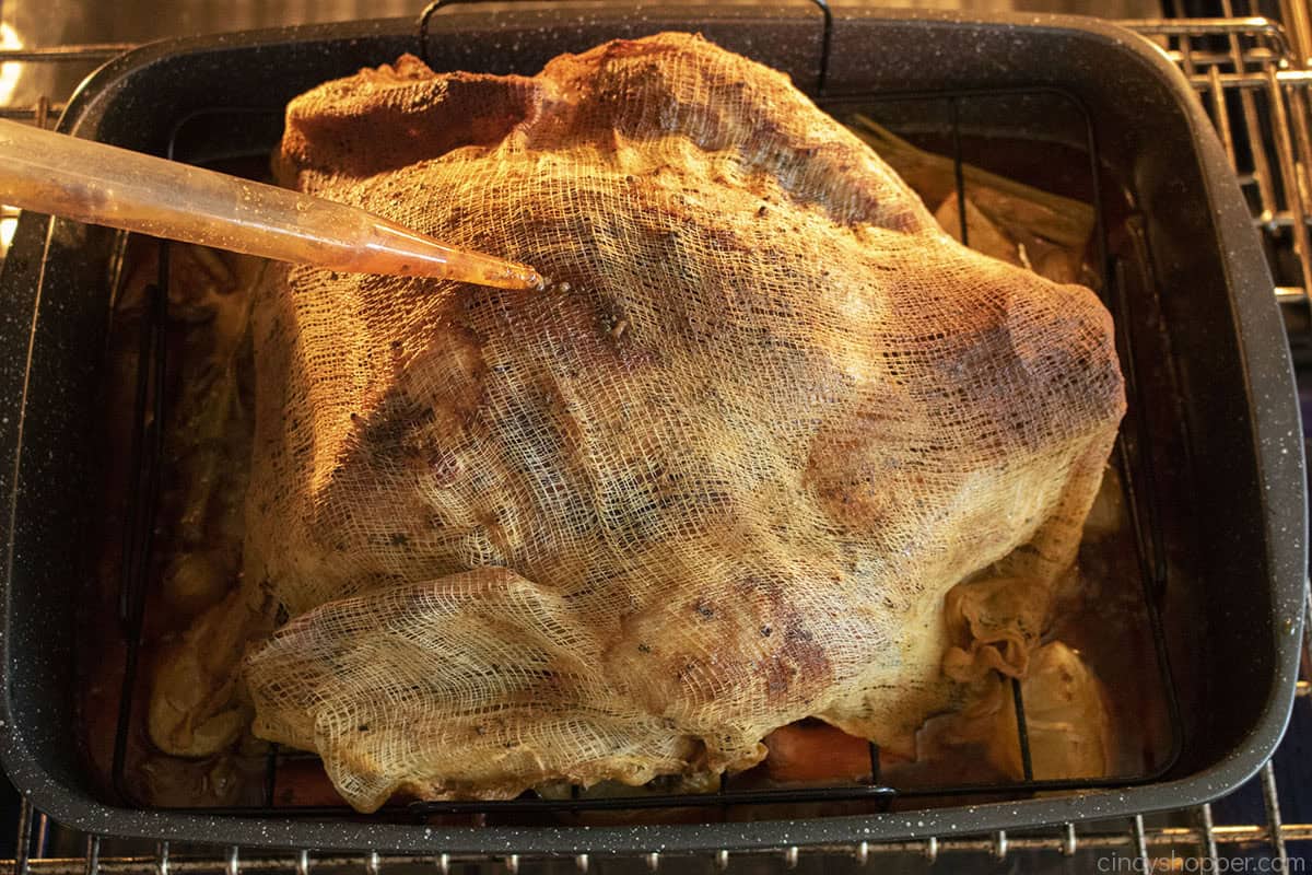 Basting cajun turkey with drippings.