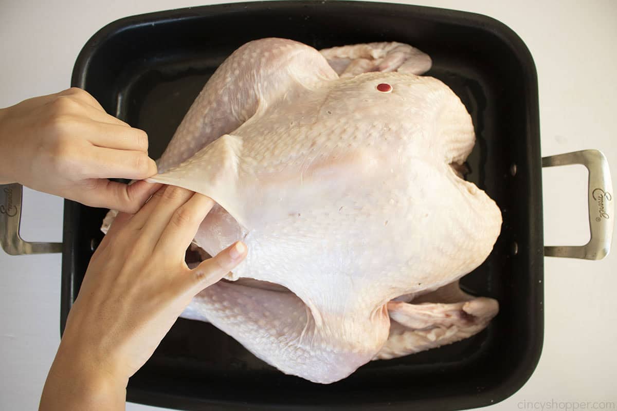 Pulling back the skin on turkey.