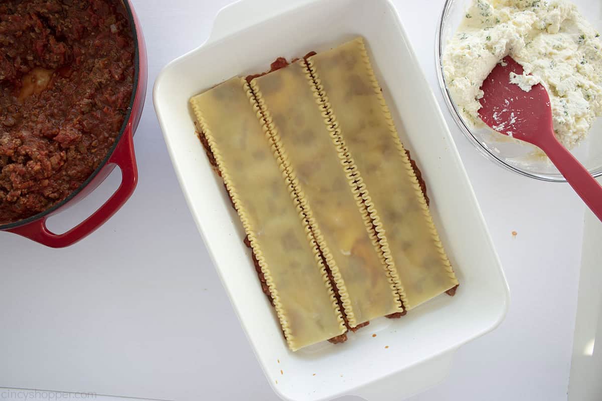 Three lasagna noodles added to casserole dishes.