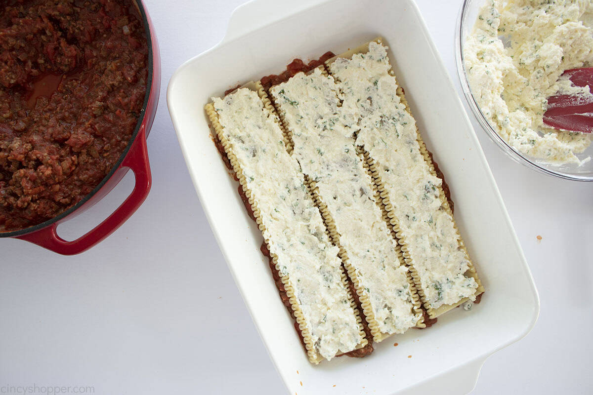 Lasagna cheese mixture added to the top of lasagna noodles.