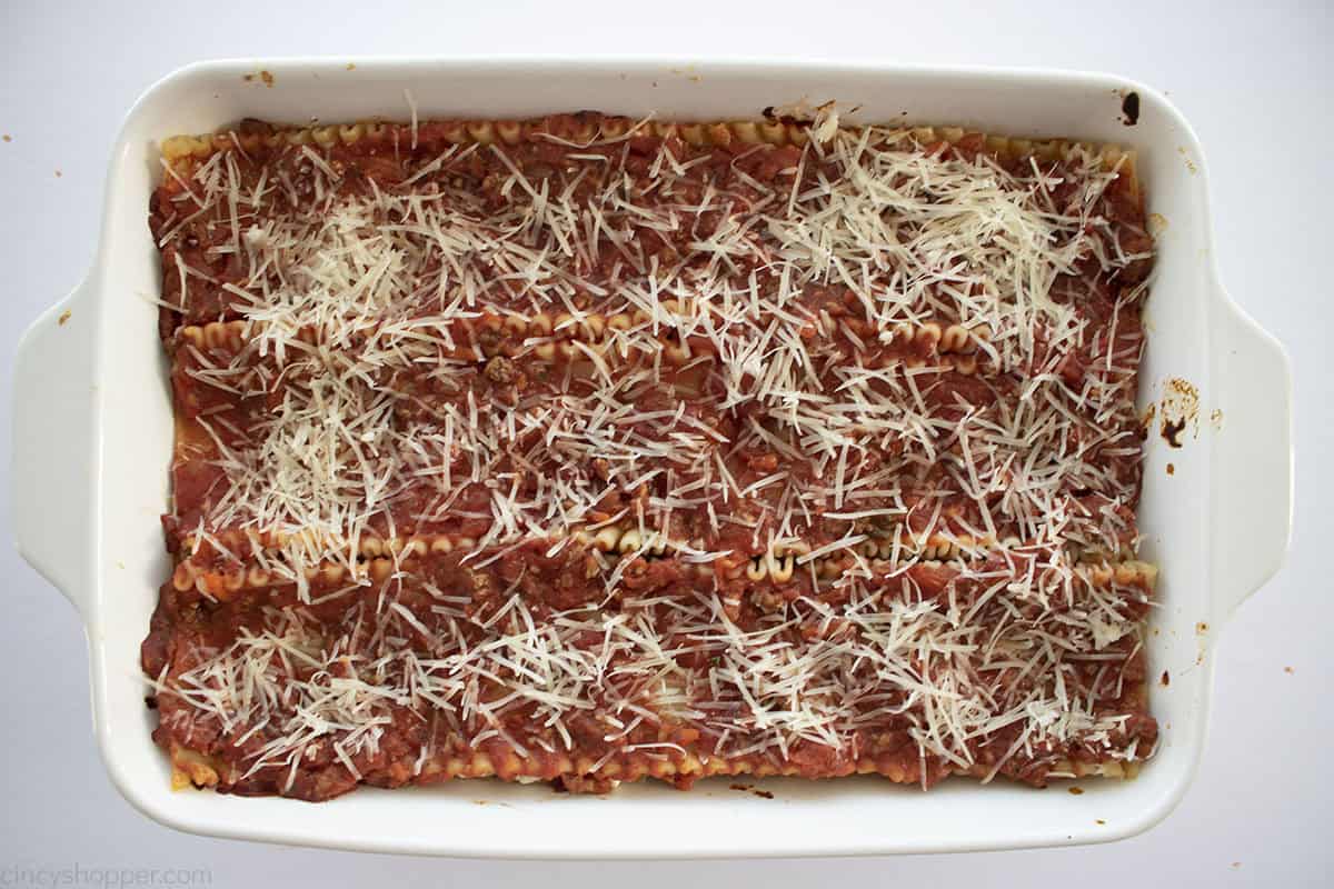 Parmesan cheese added to baked lasagna.