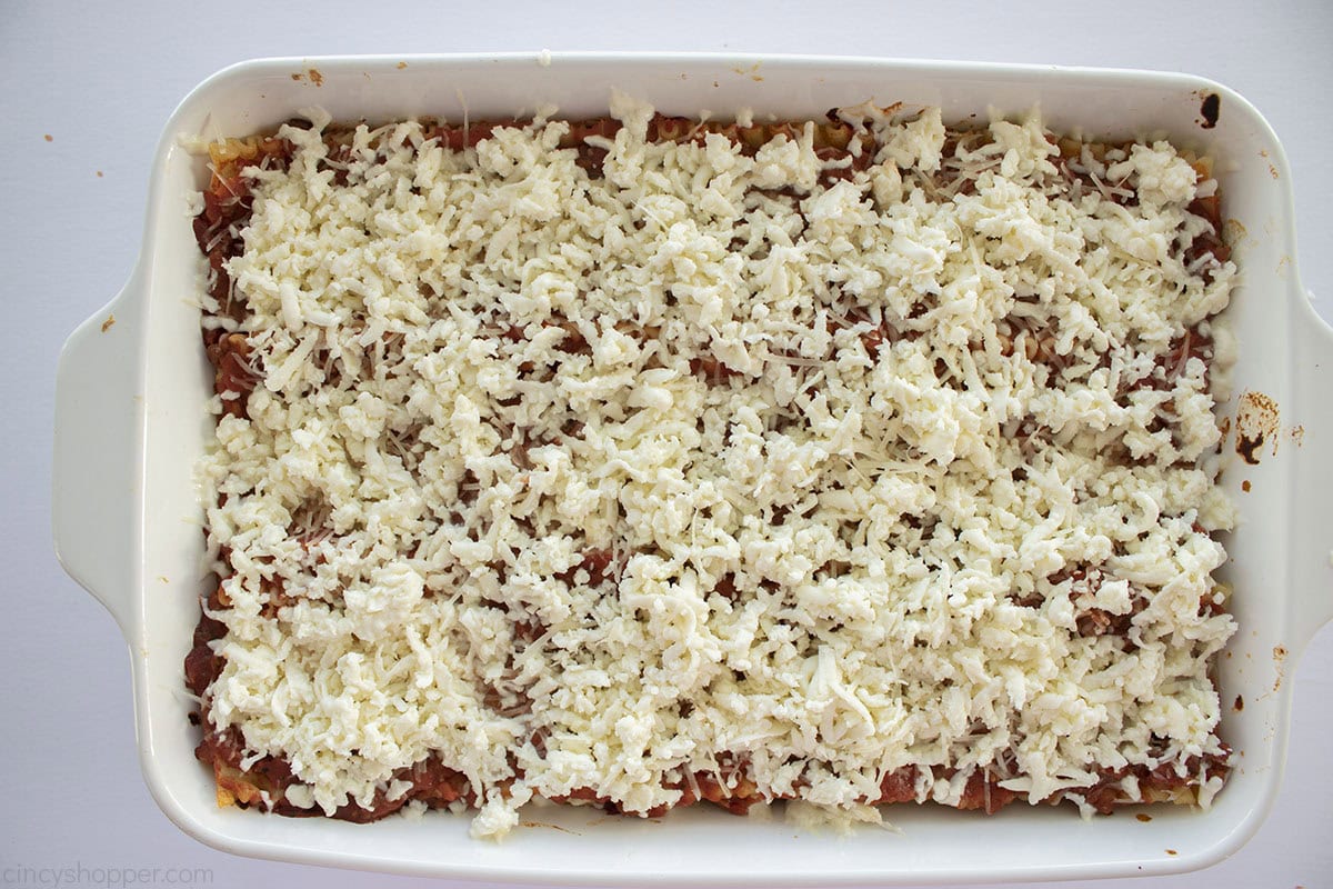 Mozzarella cheese added to the top of baked lasagna.