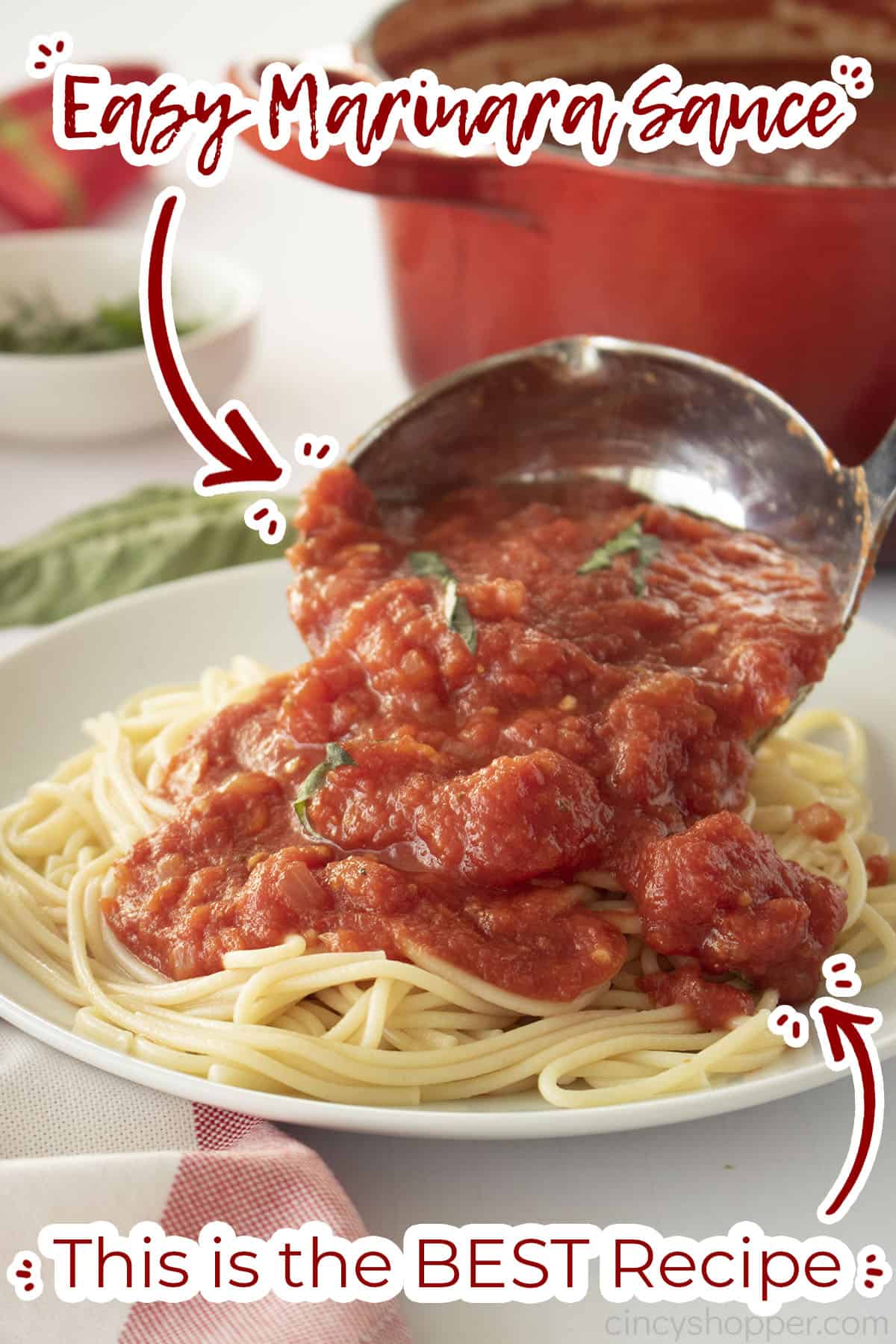 Easy Marinara Sauce in a ladle pouring over plate of spaghetti.