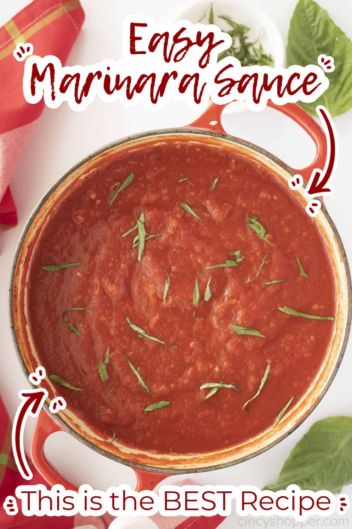 Red Dutch oven with homemade marina topped with basil. Text on image.