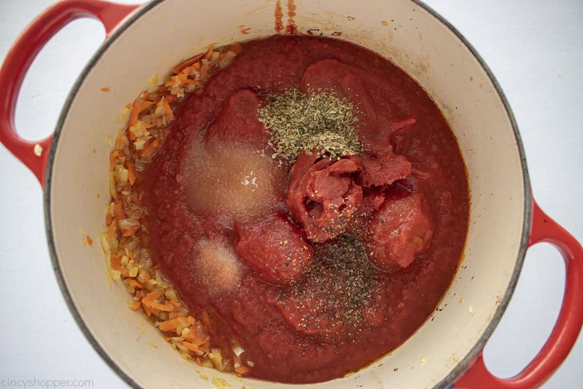 Tomatoes and spices added to carrot and onion mixture.
