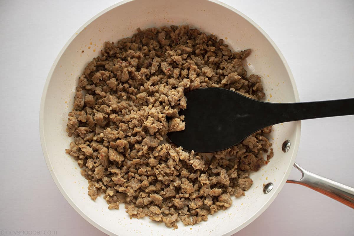 Cooked Italian sausage in a white pan.