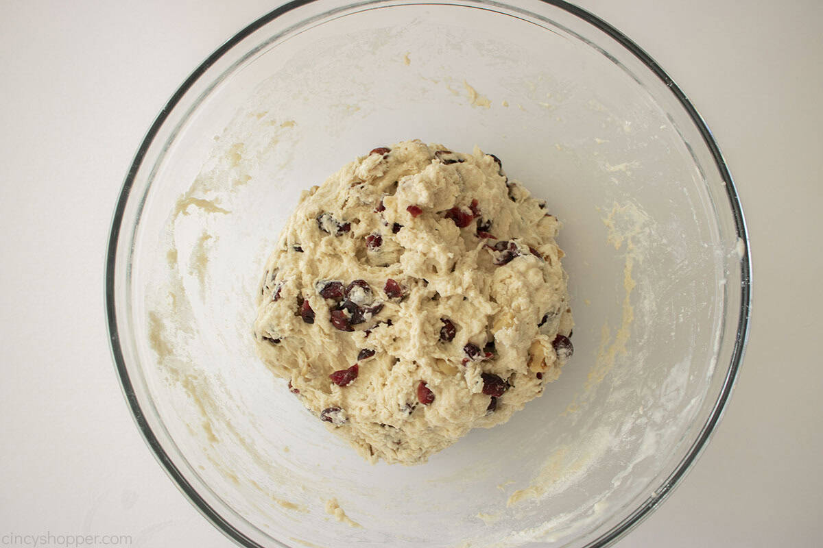Mixed ball of bread dough in a mixing bowl.
