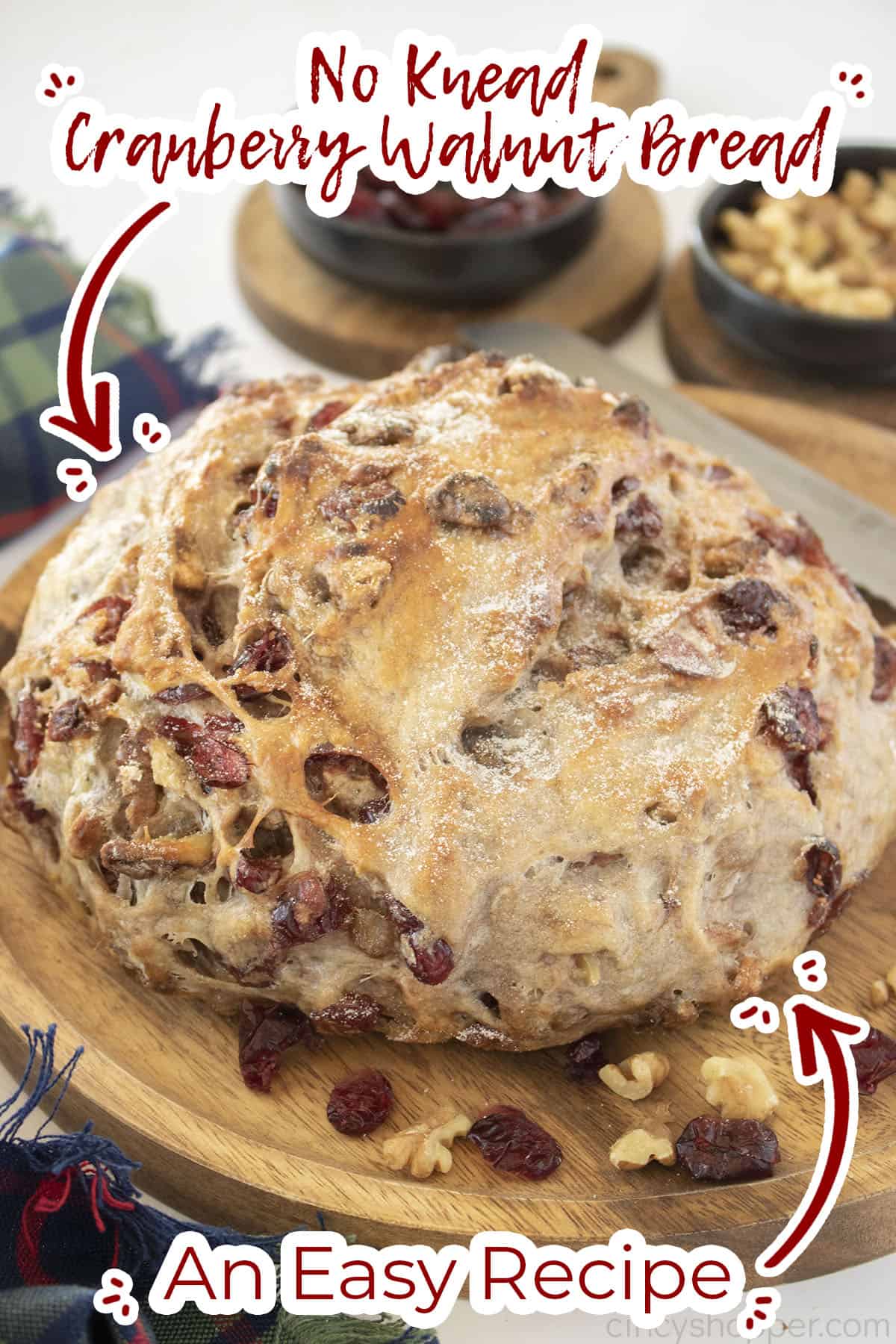 Cranberry nut bread full sized loaf on a wood board.