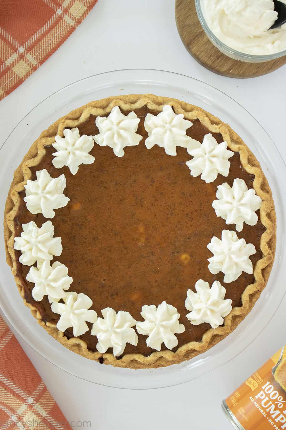 Whole Old Fashioned Pumpkin Pie in plate with Whipped Cream topping.
