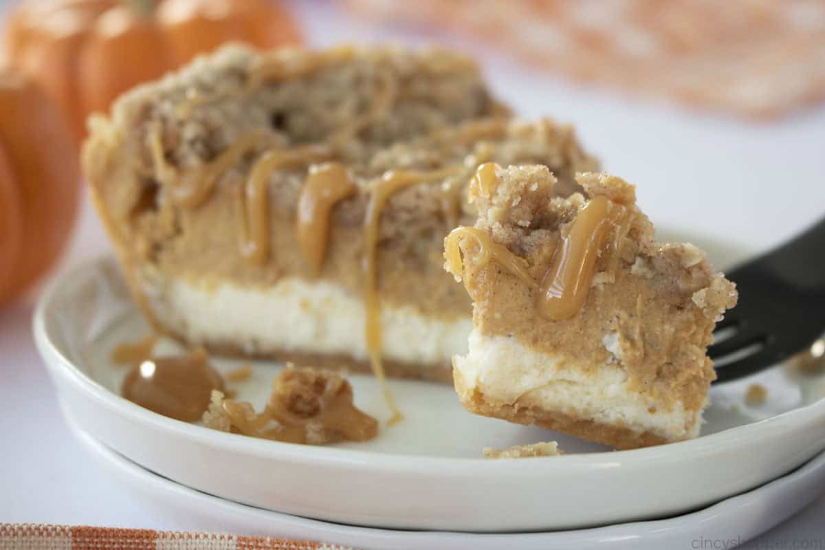 Pumpkin Cheesecake pie with caramel drizzle on a fork