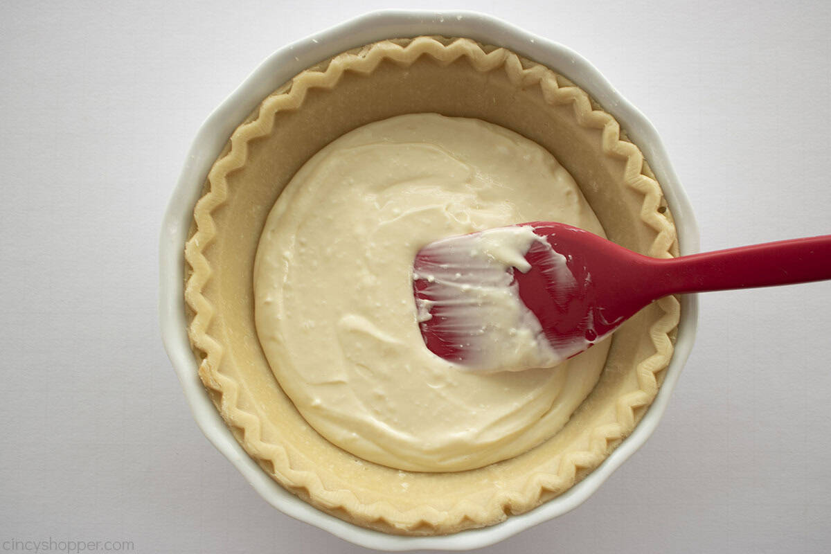 Cream cheese added to the bottom of pie crust.