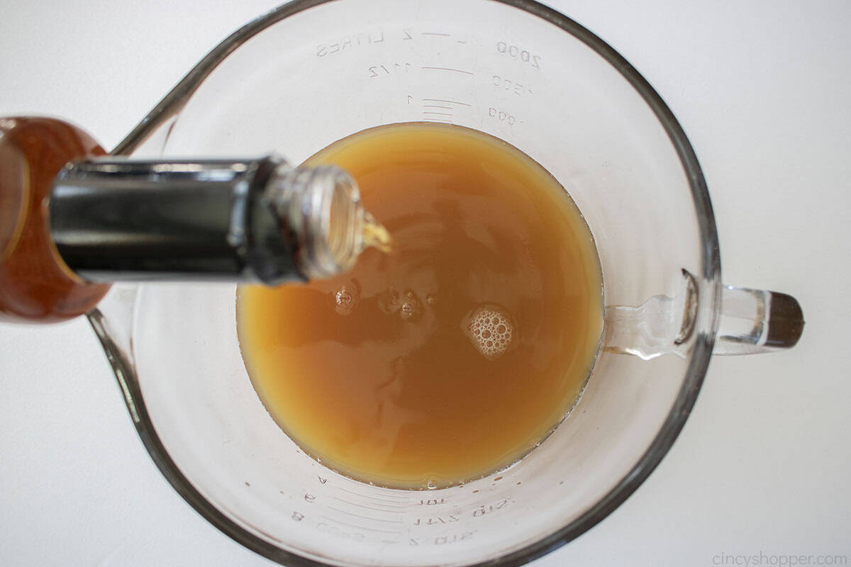 Adding caramel syrup to the apple cider in a extra large measuring cup/bowl.