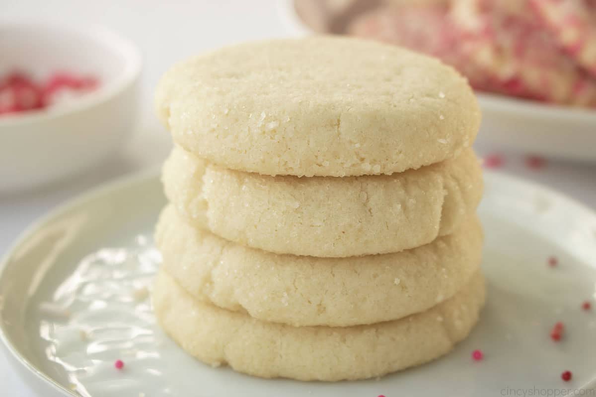 Round sugar cookies in a stack on a plate.