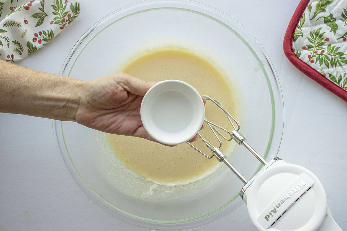 Anise extract being added to butter sugar mixture.