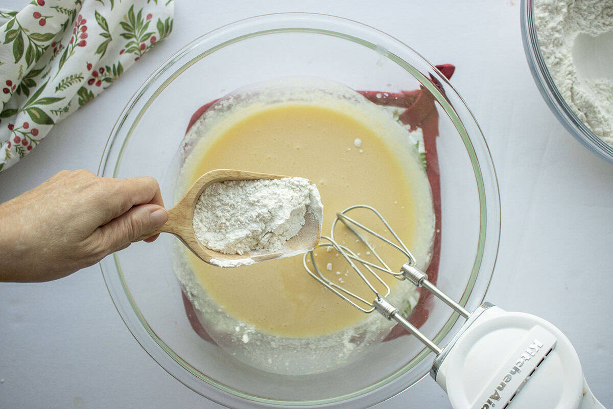 Flour being added to butter sugar mixture.