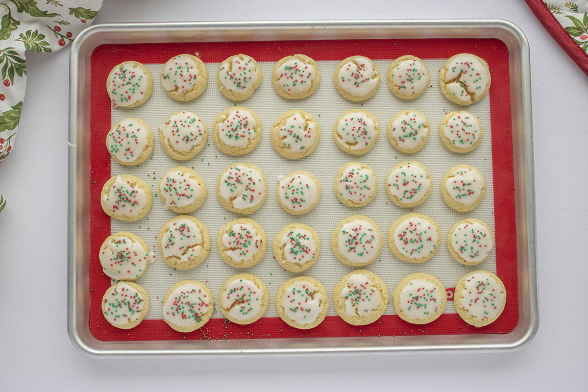 Decorated Italian Christmas cookies on a baking sheet.