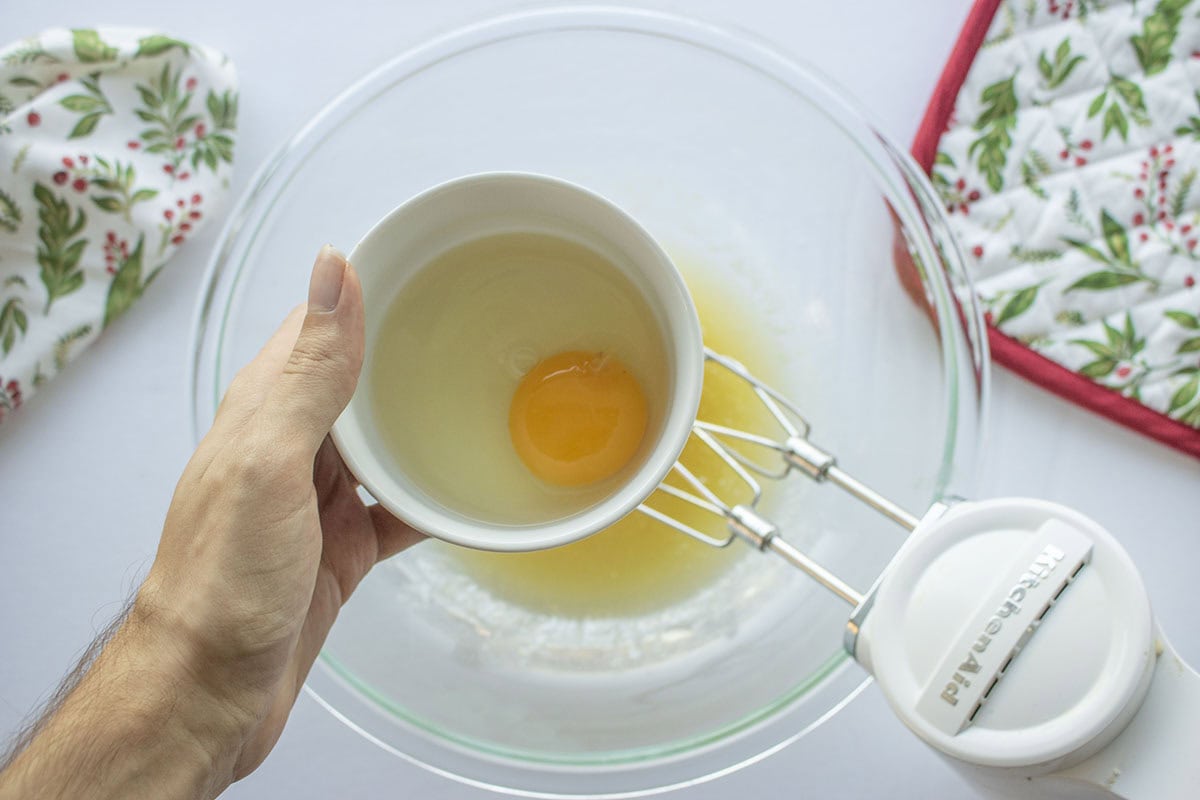 Egg being added to butter sugar mixture.