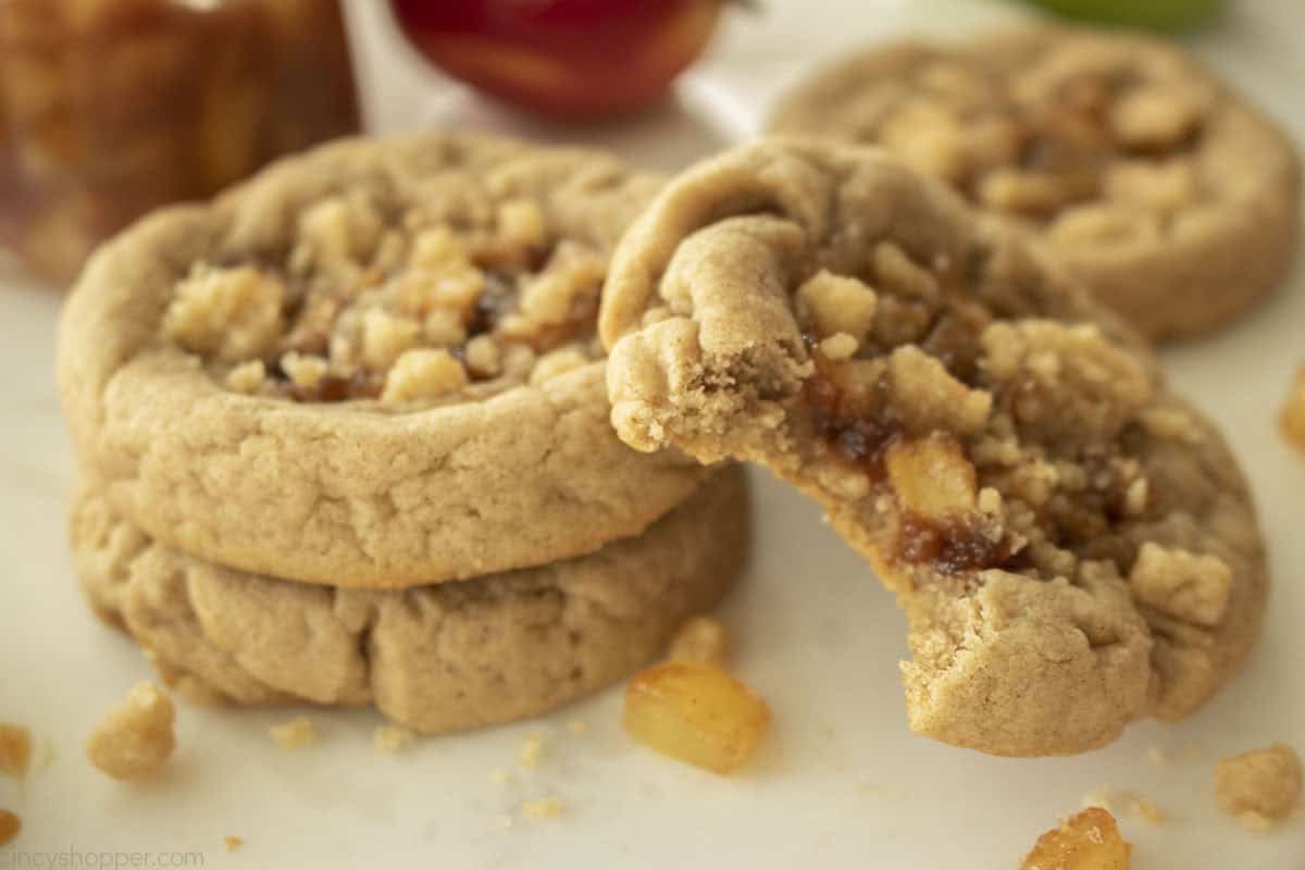 Fresh homemade apple pie cookies with a bite taken out.