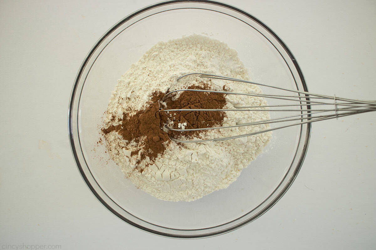 Cookie dry ingredients in a clear mixing bowl with a whisk.