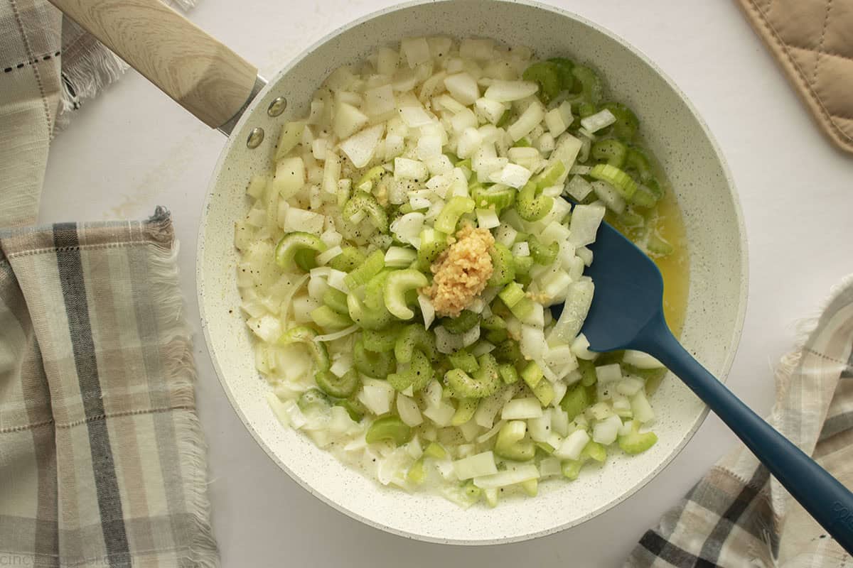 Onions, celery and garlic added to melted butter.