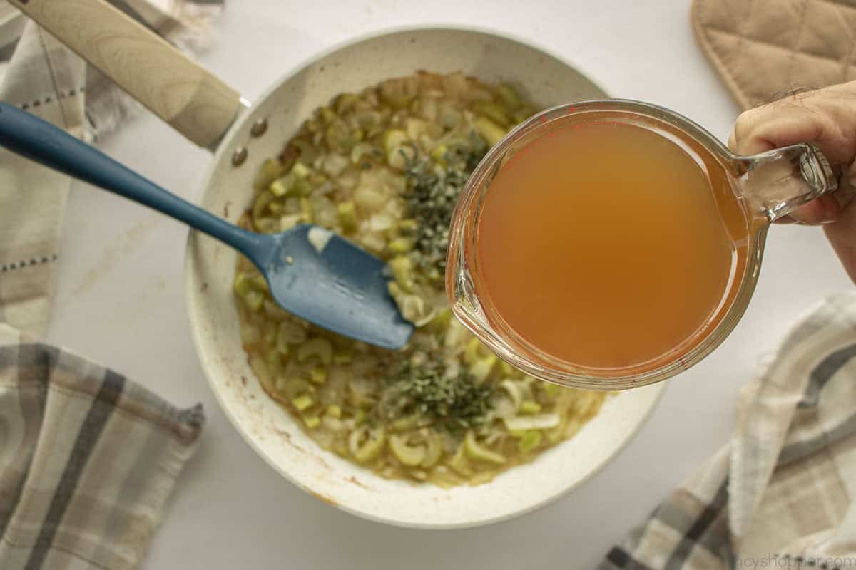 Stock added to vegeaztble and herb mixture.