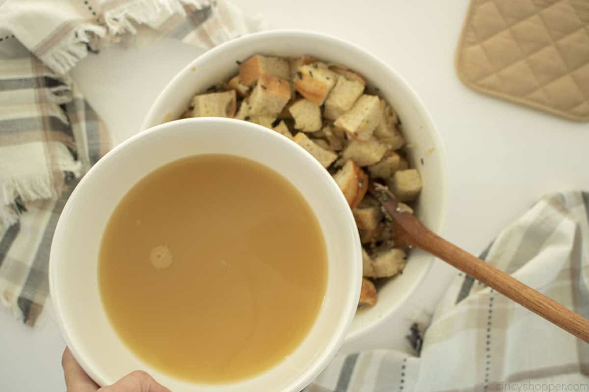 Stock added to bowl with bread.