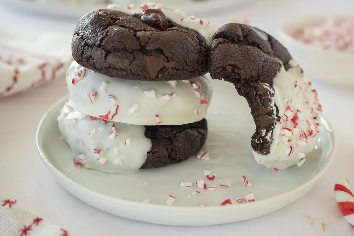 Decorated Peppermint Cookies on a white plate with candy cane pieces.