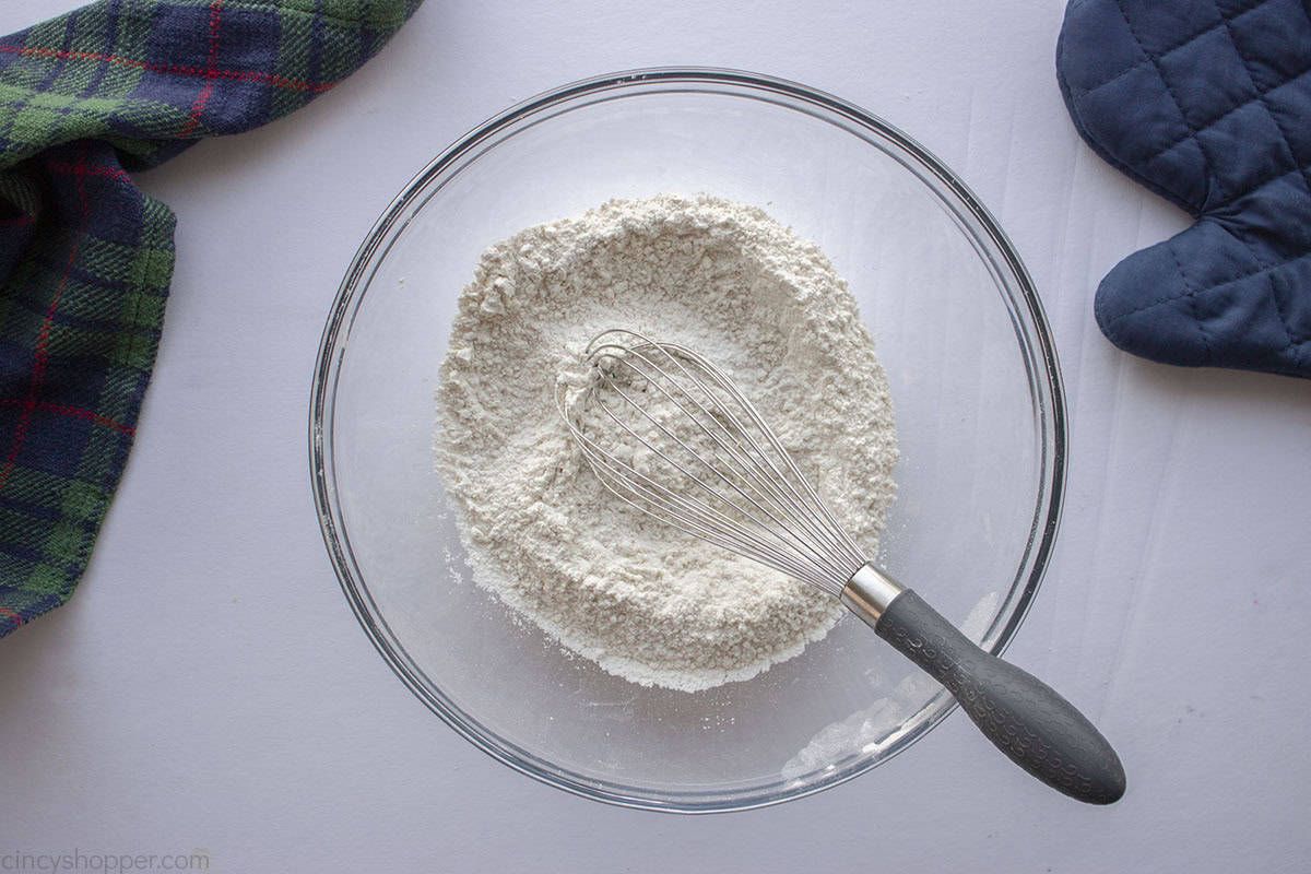 Dry cookie ingredients in a clear mixing bowl.