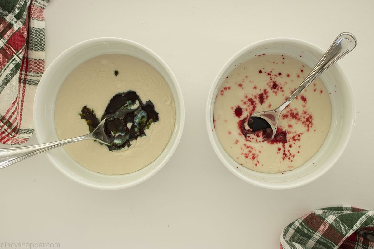 Food coloring added to two bowls of cookie icing.