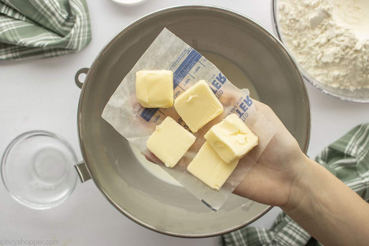 Sliced softened butter added to mixture.