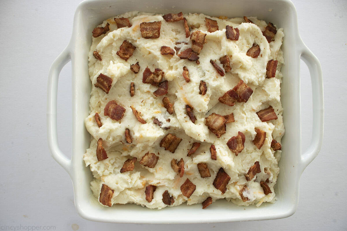 Crispy bacon pieces added to the top of mashed potato casserole.