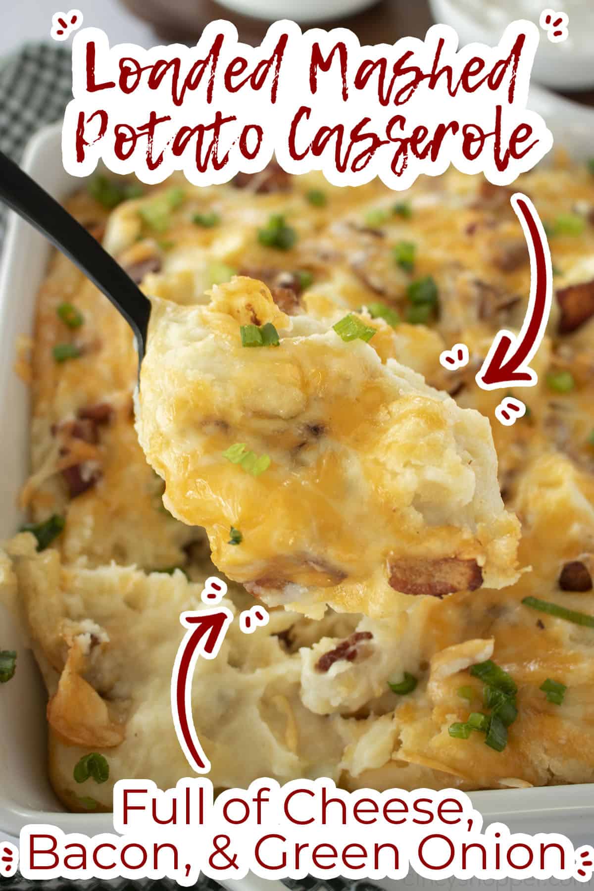 Mashed Potato Casserole on a spoon with text on image full of cheese, bacon and green onion. 