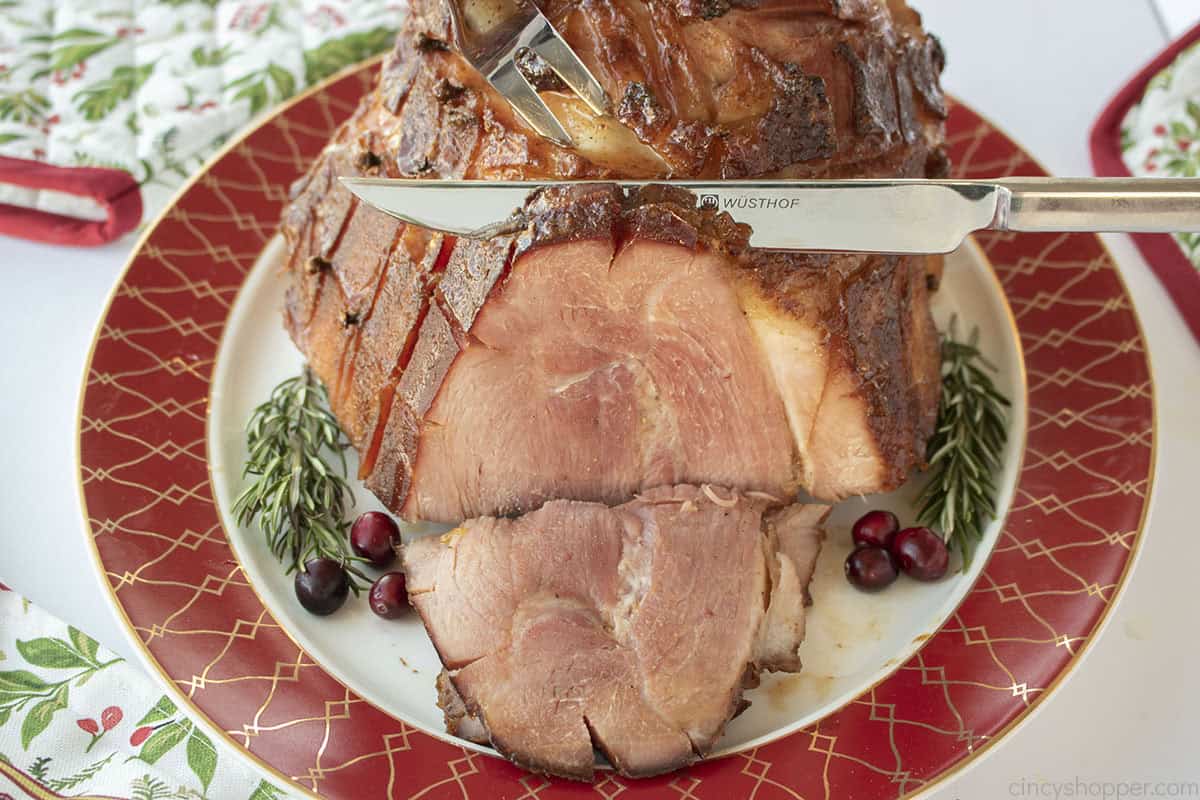 Horizontal image of maple ham being sliced.