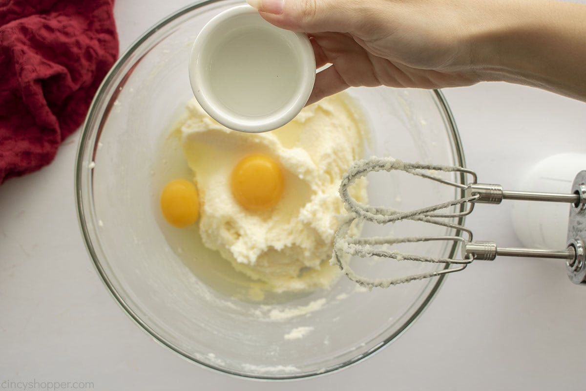 Adding Almond extract to butter sugar egg mixture.
